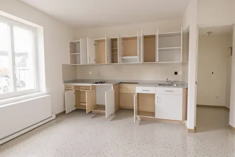An empty apartment with cabinets open and floors cleared, ready for inspection