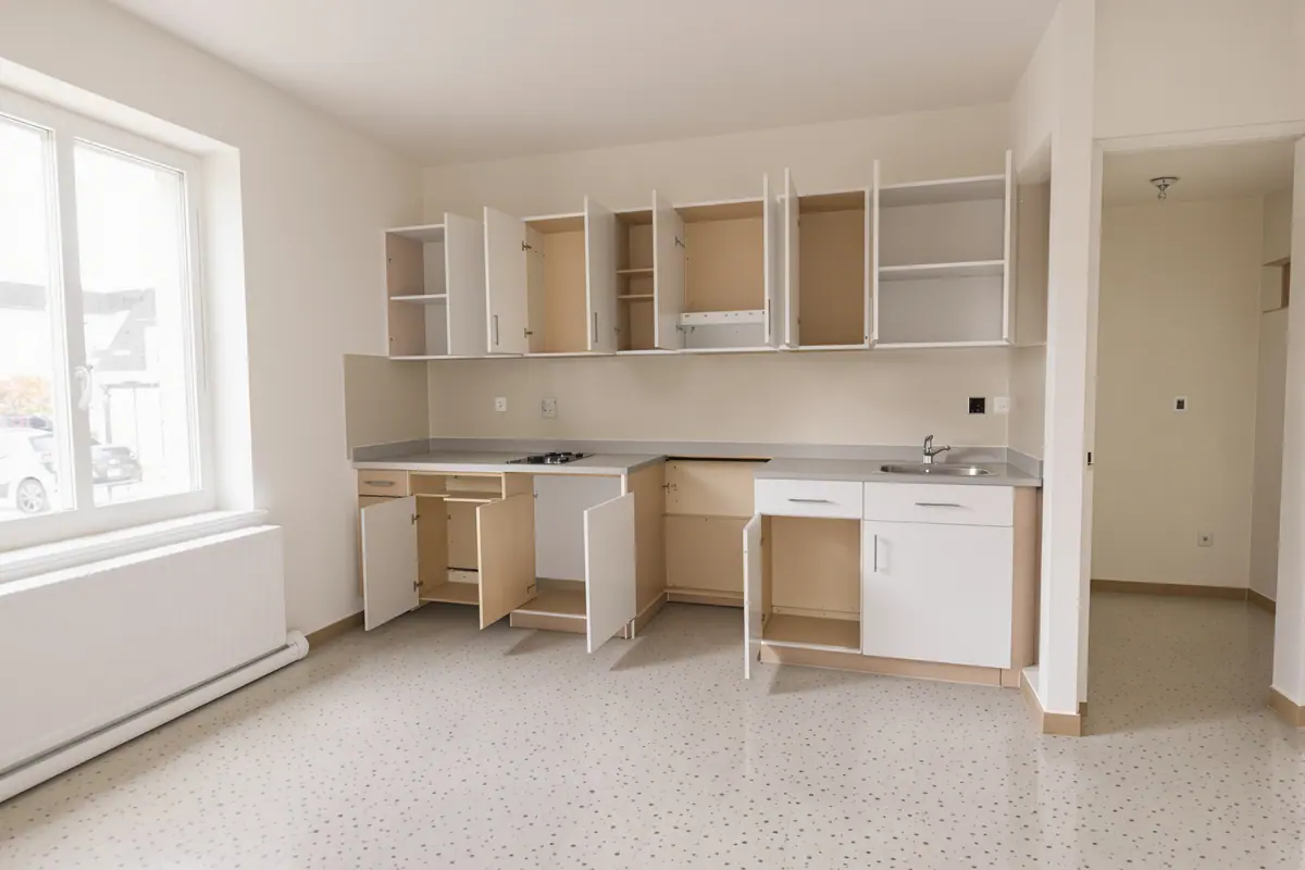 An empty apartment with cabinets open and floors cleared, ready for inspection